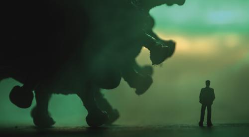 Corona virus graphic lurking behind man figure 