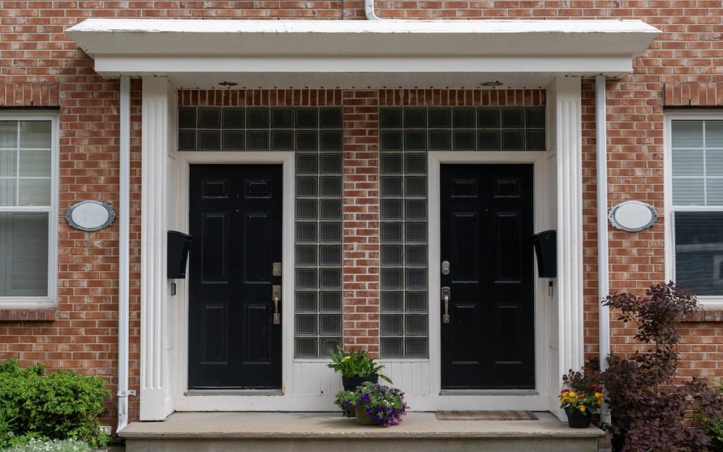 A closeup of two doors in a duplex