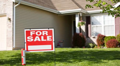 Single-family home with red "For Sale" sign on front lawn