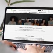 A student looks at the Houzz scholarship landing page on a laptop