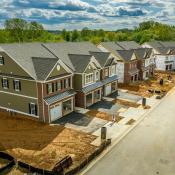 A row of new homes sits under construction