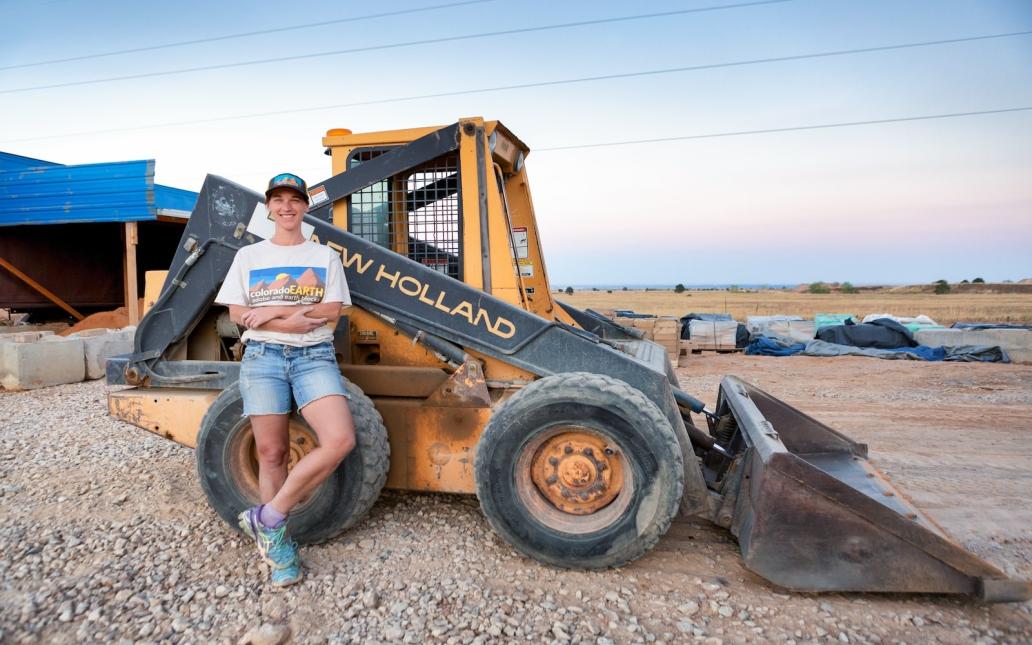 Lisa Morey, founder of Nova Terra, stands in front of machinery at a project site.