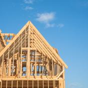 A framed single-family home against a blue sky 