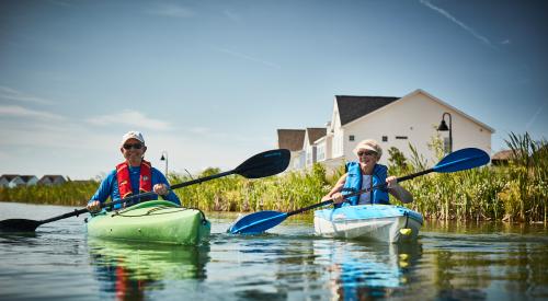 Older couple kayaking in adult living community