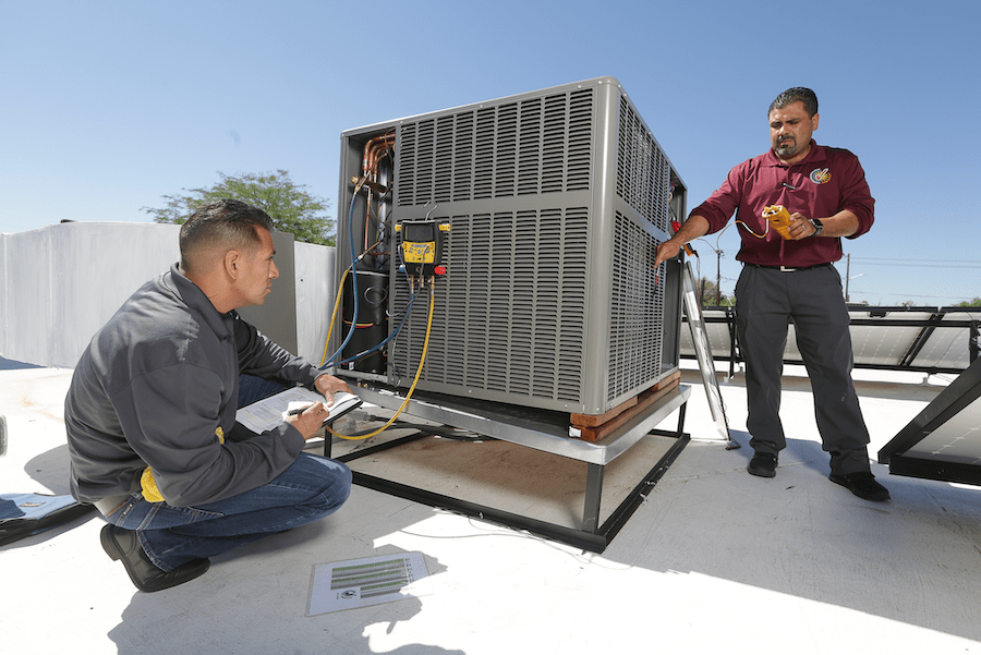 HVAC technicians using diagnostic tools to test for HVAC faults