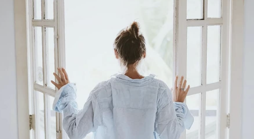 Woman letting in fresh air